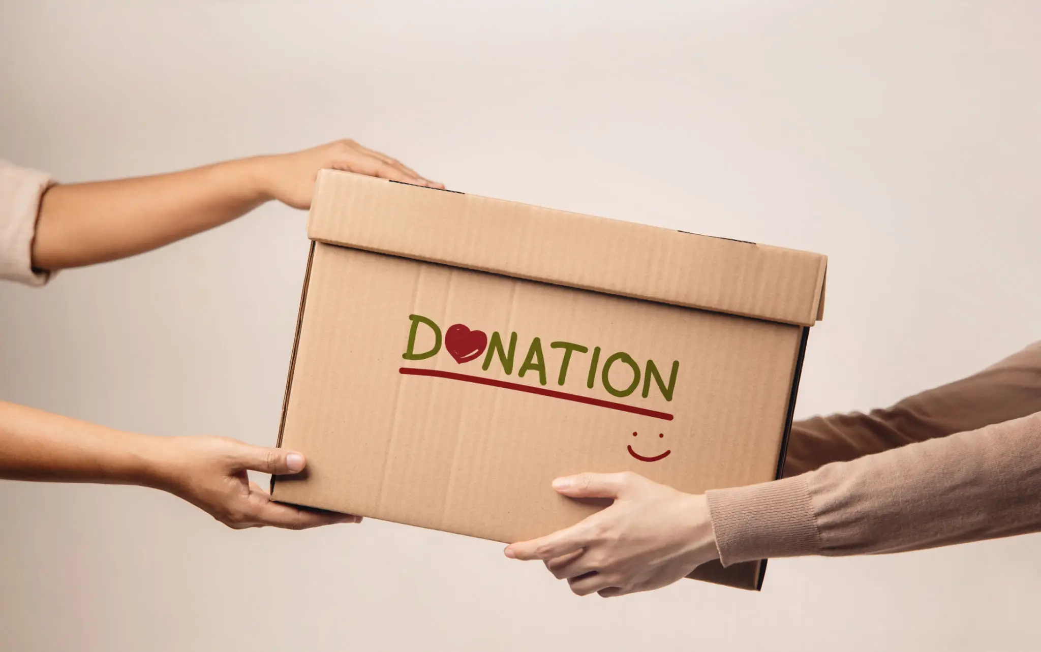 Hands exchanging a donation box.