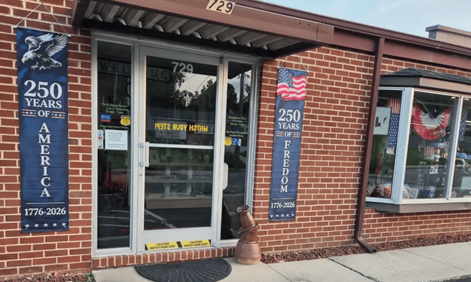 Brick building with American anniversary banners.