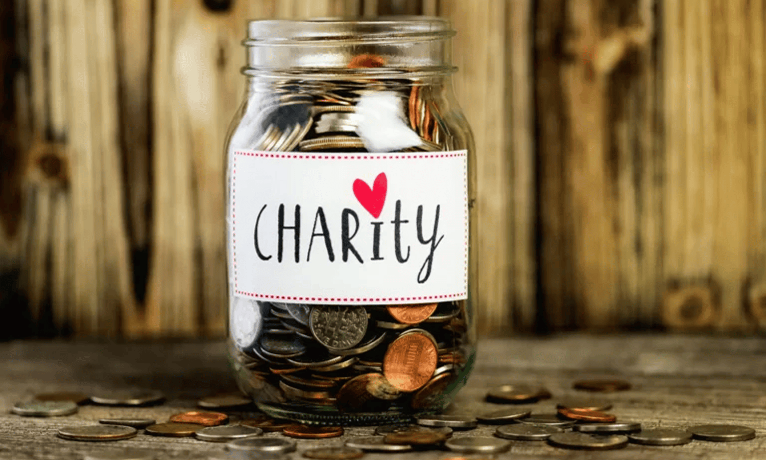 Jar labeled "Charity" filled with coins.